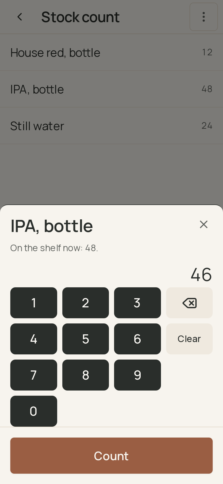 The stock count on a phone: the count sheet for bottled IPA with 48 on the shelf, 46 typed on the keypad, and the Count button. · shown in English