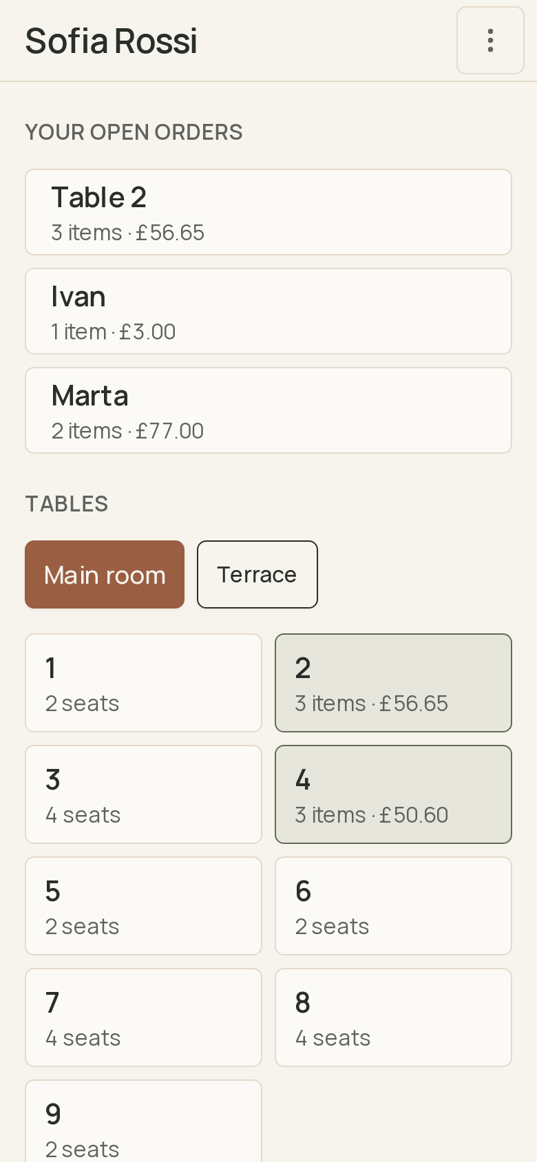 The phone's tables screen: the waiter's open orders at the top, then the main room's tables, each with its seats or what is on its bill. · shown in English
