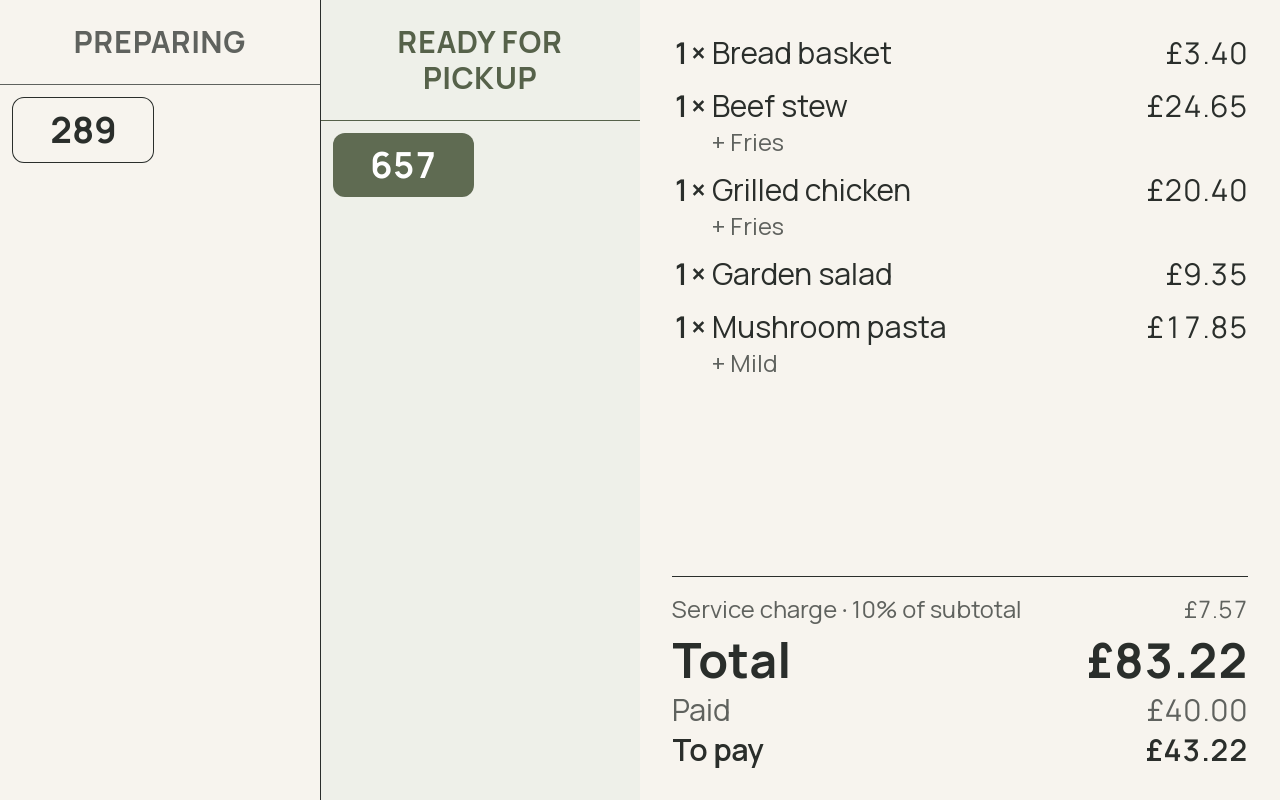 A customer-facing screen showing a bill line by line with a service charge on it, next to a pickup board with orders under preparing and ready. · shown in English